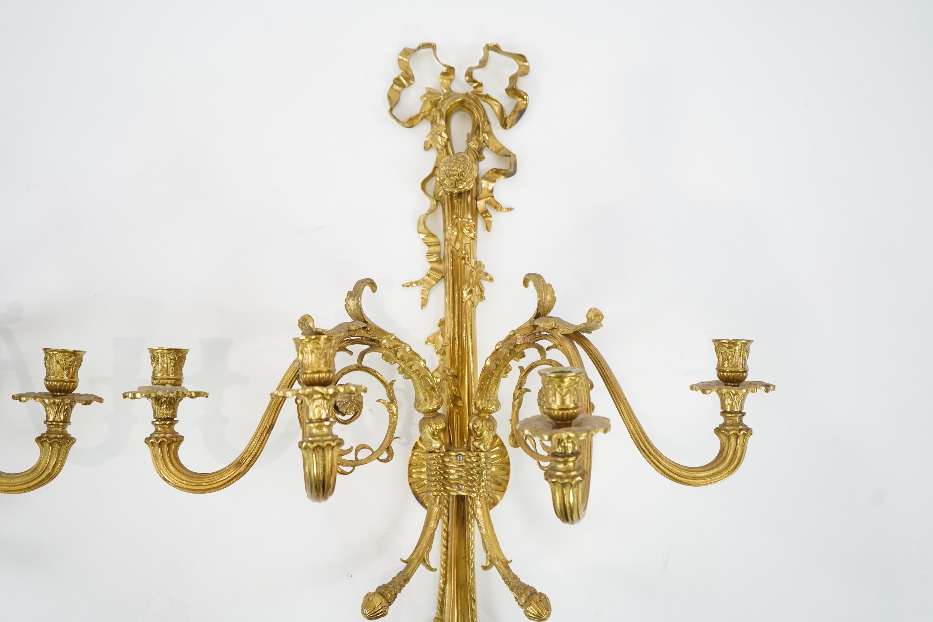 A pair of large Louis XVI style ormolu four branch wall sconces